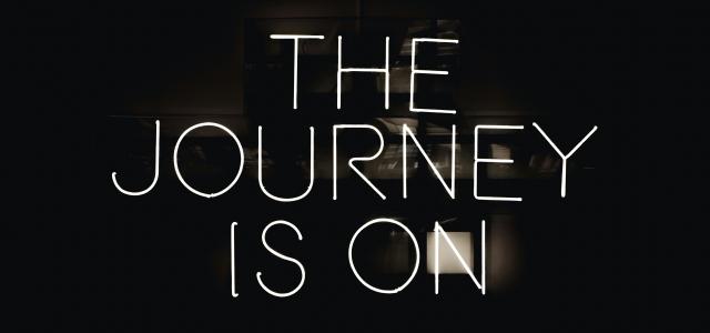 a black and white photo with the words the journey is on by Maxime Horlaville courtesy of Unsplash.